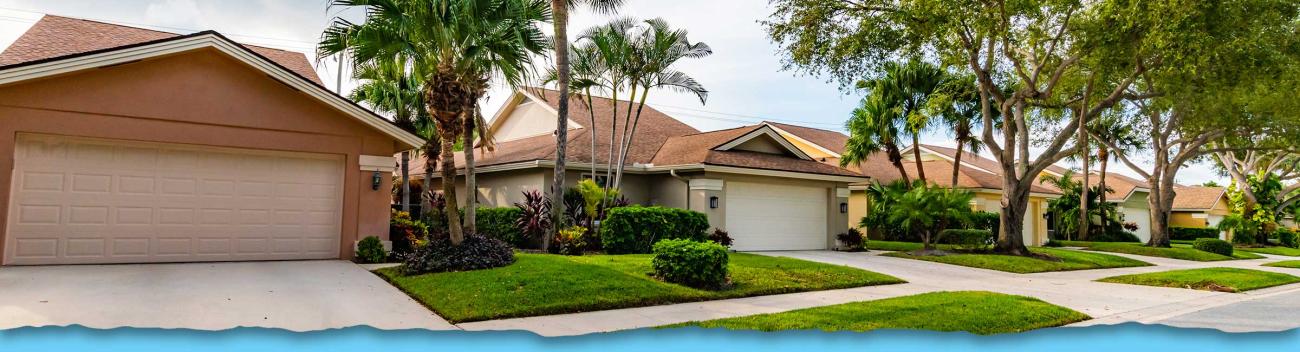 Surburban Florida community street with lawns and driveways