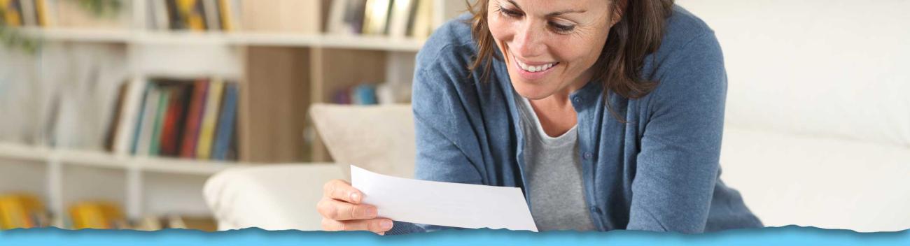 Smiling woman looking at check