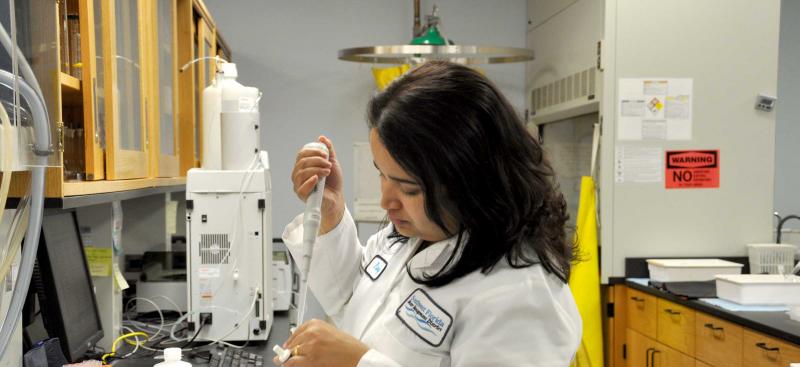 staff member testing water in chemistry lab