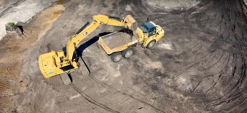 Excavator and dump truck