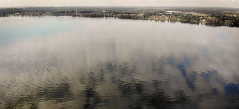 Aerial view of lake with shoreline on a cloudy day