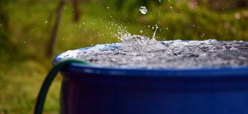 water splashing on rain barrel