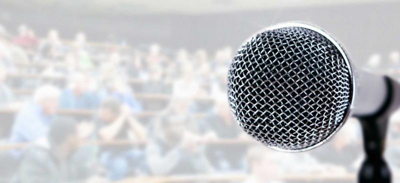 Microphone with audience in background