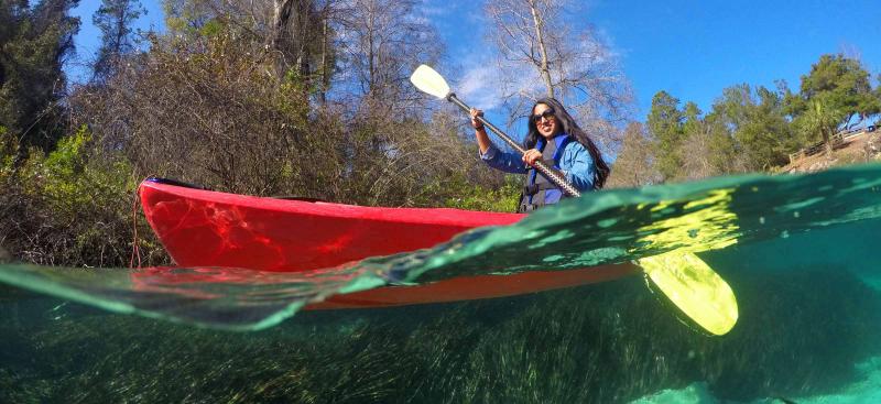 girl in red kayak in clear Florida spring water