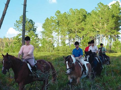 riders on horesback on District property