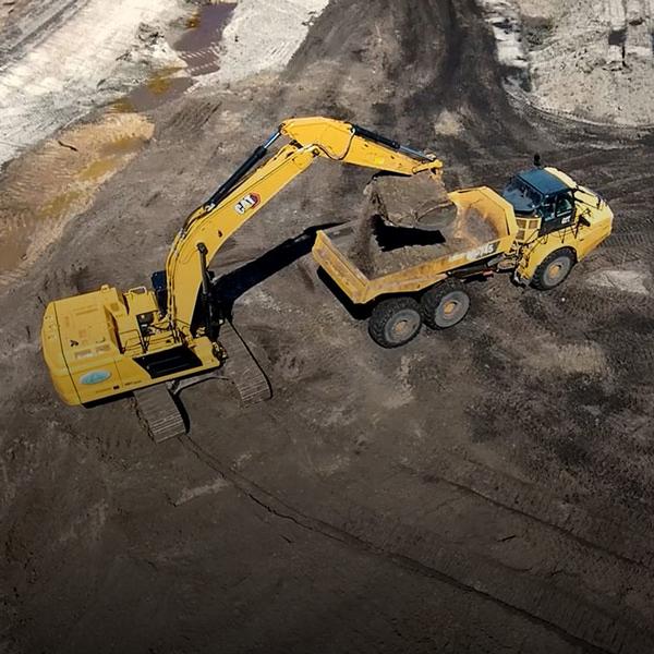 Excavator and dump truck
