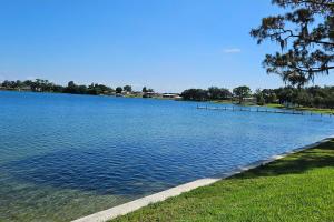 Grassy bank beside a blue lake under a sunny blue sky