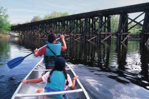 Canoeing on Peace River near trestle bridge