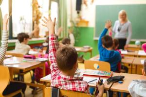 students wanting to answer question in classroom