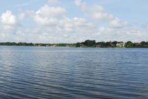 Panorama of Florida lake with homes on tree-lined far shore