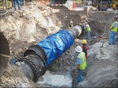 Workers installing pipeline