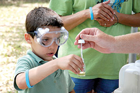 boy performing water quality test
